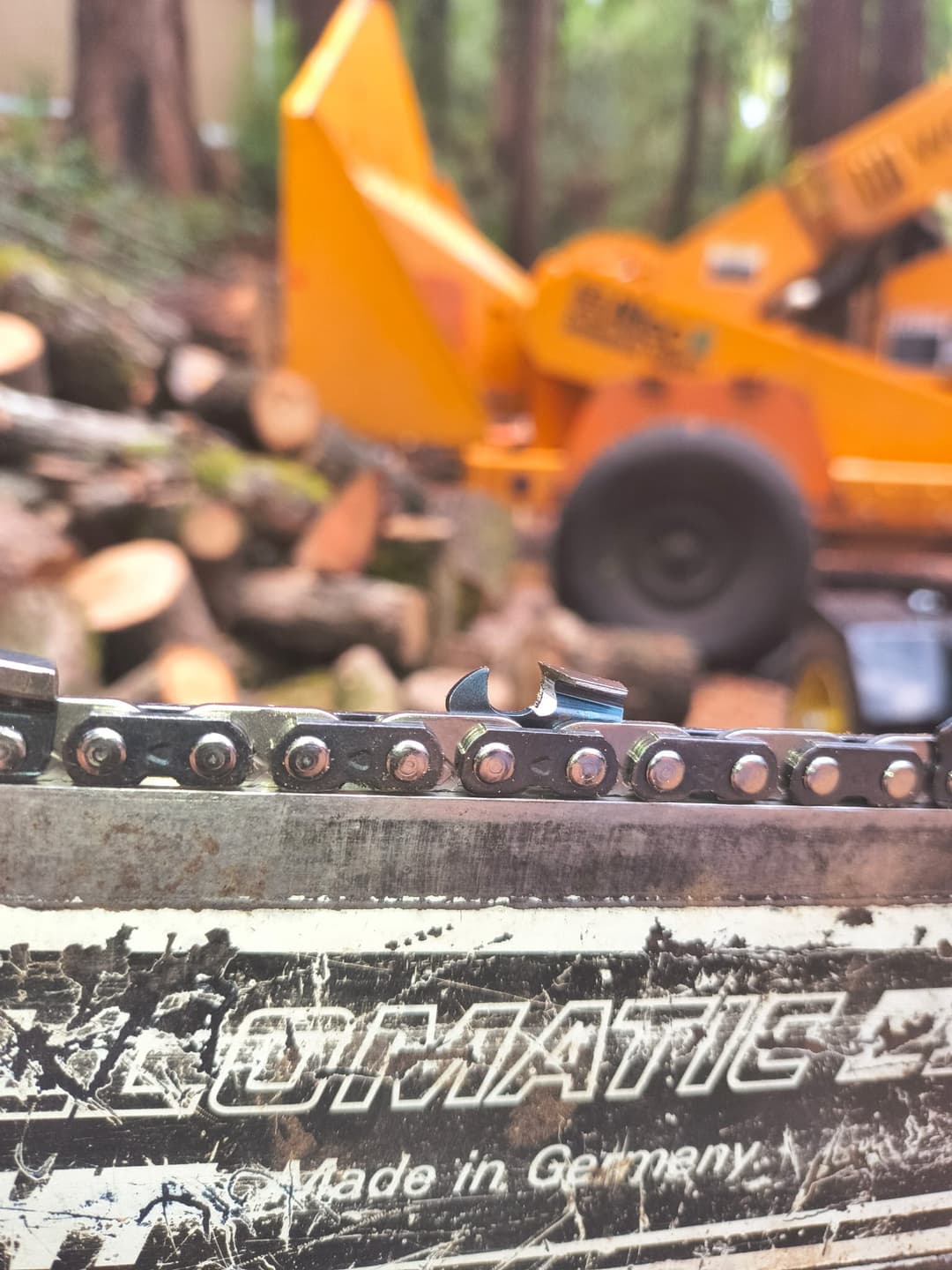 Close-up view of wood chipper blades cutting tree branches