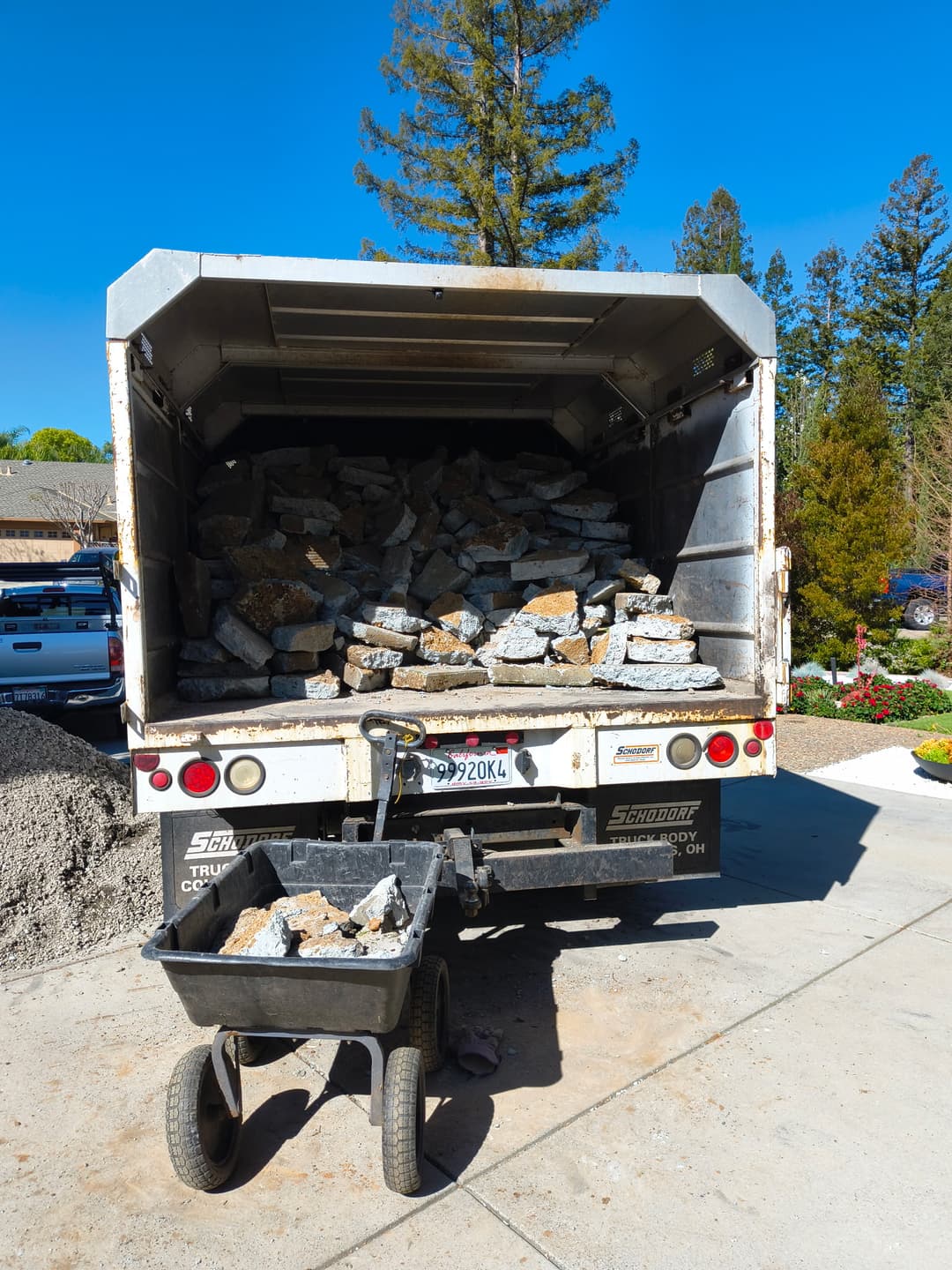 Dump truck fully loaded with broken concrete and rock debris for hauling and debris removal service